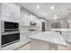 Modern kitchen with white cabinets, quartz counters, and stainless steel appliances at 32029 N 20Th Ln, Phoenix, AZ 85085