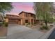 Two-story home with covered entryway and desert landscaping at sunset at 32029 N 20Th Ln, Phoenix, AZ 85085