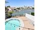 Stunning pool and patio overlooking a tranquil lake with boats and lush landscaping at 3210 N 108Th Ln, Avondale, AZ 85392