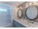 Double vanity bathroom with marble countertop and decorative mirrors at 2650 W Union Hills Dr # 236, Phoenix, AZ 85027