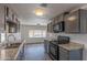 Modern kitchen with gray cabinets, granite countertops, and stainless steel appliances at 2650 W Union Hills Dr # 236, Phoenix, AZ 85027