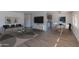 Living room with staged furniture, large TV, and dining area at 2650 W Union Hills Dr # 236, Phoenix, AZ 85027