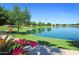 Scenic community lake with walking path and lush landscaping at 9848 E Sunburst Dr, Sun Lakes, AZ 85248