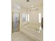 Bathroom with soaking tub, shower, and a window at 9848 E Sunburst Dr, Sun Lakes, AZ 85248