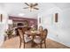 Bright dining area with wooden table and chairs, offering a view of the living room at 13467 W Desert Glen Dr, Sun City West, AZ 85375