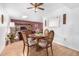 Bright dining area with wooden table and chairs, offering a view of the living room at 13467 W Desert Glen Dr, Sun City West, AZ 85375