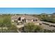 Home's exterior with stone accents and three-car garage at 36495 N Livorno Way, Scottsdale, AZ 85262