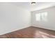 Simple bedroom with a window and wood-look flooring at 7313 E Jasmine St, Mesa, AZ 85207