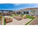 Landscaped backyard oasis with a fire pit, seating area, and pergola at 19980 E El Nido Ln, Litchfield Park, AZ 85340