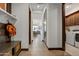 Bright hallway with light wood floors and access to laundry and dining areas at 19980 E El Nido Ln, Litchfield Park, AZ 85340