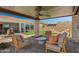 Covered patio with comfortable seating and views of the backyard and mountains at 19980 E El Nido Ln, Litchfield Park, AZ 85340