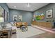 Finished recreation room with leather couch and built-in shelving at 19980 E El Nido Ln, Litchfield Park, AZ 85340