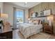 Comfortable guest bedroom with wood-paneled accent wall and large window at 19980 E El Nido Ln, Litchfield Park, AZ 85340