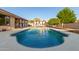 Beautiful kidney-shaped pool surrounded by a large patio and landscape at 12311 W Tigerseye Dr, Sun City West, AZ 85375