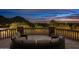 Stone balcony with circular seating area, offering scenic mountain and city views at 23036 N Via Ventosa Dr, Scottsdale, AZ 85255