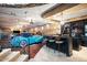 Stunning home bar adjacent to a spacious garage with classic cars at 23036 N Via Ventosa Dr, Scottsdale, AZ 85255