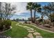 Landscaped backyard with a tennis court and stone pathway at 23036 N Via Ventosa Dr, Scottsdale, AZ 85255