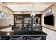 Dark wood home bar with granite countertop and ample storage at 23036 N Via Ventosa Dr, Scottsdale, AZ 85255