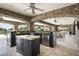 Outdoor kitchen features a large island, grill, and bar; ideal for summer entertaining at 23036 N Via Ventosa Dr, Scottsdale, AZ 85255