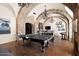 Game room features a ping pong table, foosball table, and vaulted ceilings at 23036 N Via Ventosa Dr, Scottsdale, AZ 85255