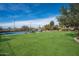 Tennis court and expansive grassy backyard with mountain views at 23036 N Via Ventosa Dr, Scottsdale, AZ 85255