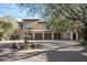 Elegant stone house with a fountain and a three-car garage at 23036 N Via Ventosa Dr, Scottsdale, AZ 85255