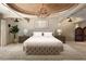 Elegant main bedroom with a large bed, chandelier, and ornate ceiling at 23036 N Via Ventosa Dr, Scottsdale, AZ 85255