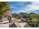 Elegant stone patio with mountain backdrop and manicured landscaping at 23036 N Via Ventosa Dr, Scottsdale, AZ 85255