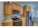 Stainless steel appliances and wood cabinets in this well-lit kitchen at 392 W Twin Peaks Pkwy, San Tan Valley, AZ 85143