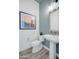 Stylish powder room with a pedestal sink and wood-look tile floor at 19974 E El Nido Ln, Litchfield Park, AZ 85340