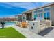 Luxury outdoor kitchen with stainless steel appliances and seating area at 19974 E El Nido Ln, Litchfield Park, AZ 85340