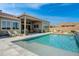 Inviting backyard oasis featuring a sparkling pool with a water feature and relaxing patio furniture at 19974 E El Nido Ln, Litchfield Park, AZ 85340
