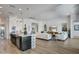 Open floor plan showcases kitchen island, living area, and hardwood floors at 19974 E El Nido Ln, Litchfield Park, AZ 85340