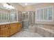 Bathroom with shower, tub, and wood vanity at 28352 N 124Th Dr, Peoria, AZ 85383