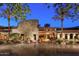 Elegant clubhouse exterior at night with stone facade and landscaping at 28352 N 124Th Dr, Peoria, AZ 85383