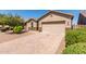 Charming one-story home with a beige stucco exterior and brick driveway at 1966 W Larissa Ln, San Tan Valley, AZ 85144