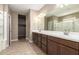 Double vanity bathroom with large mirror and tiled floor at 3164 N 300Th Dr, Buckeye, AZ 85396