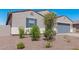 New construction home with gray garage and desert landscaping at 3454 E Jasmine Way, San Tan Valley, AZ 85143