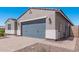 New construction home with gray garage and desert landscaping at 3454 E Jasmine Way, San Tan Valley, AZ 85143