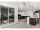 Open kitchen with island, dark cabinets, and sliding door to patio at 3454 E Jasmine Way, San Tan Valley, AZ 85143