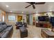 Living room with stone fireplace, leather furniture, and hardwood floors at 1525 W Maddock Rd, Phoenix, AZ 85086