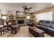 Living room with stone fireplace, leather furniture, and hardwood floors at 1525 W Maddock Rd, Phoenix, AZ 85086