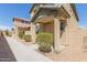 Tan two-story house with front walkway, landscaping, and a covered entryway at 812 E Agua Fria Ln, Avondale, AZ 85323