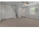 Living room with carpet flooring, neutral walls, and a staircase at 812 E Agua Fria Ln, Avondale, AZ 85323