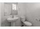 Simple, clean bathroom with pedestal sink and toilet at 812 E Agua Fria Ln, Avondale, AZ 85323