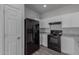 Modern kitchen features black appliances and white cabinets at 812 E Agua Fria Ln, Avondale, AZ 85323