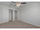 Bedroom with ceiling fan, closet, and carpet flooring at 812 E Agua Fria Ln, Avondale, AZ 85323