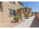Tan two-story house with a walkway and neatly landscaped yard at 812 E Agua Fria Ln, Avondale, AZ 85323