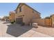 Two-story house with brown garage door and a wooden gate at 812 E Agua Fria Ln, Avondale, AZ 85323