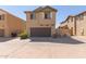 Two-story house with brown garage door and landscaping at 812 E Agua Fria Ln, Avondale, AZ 85323